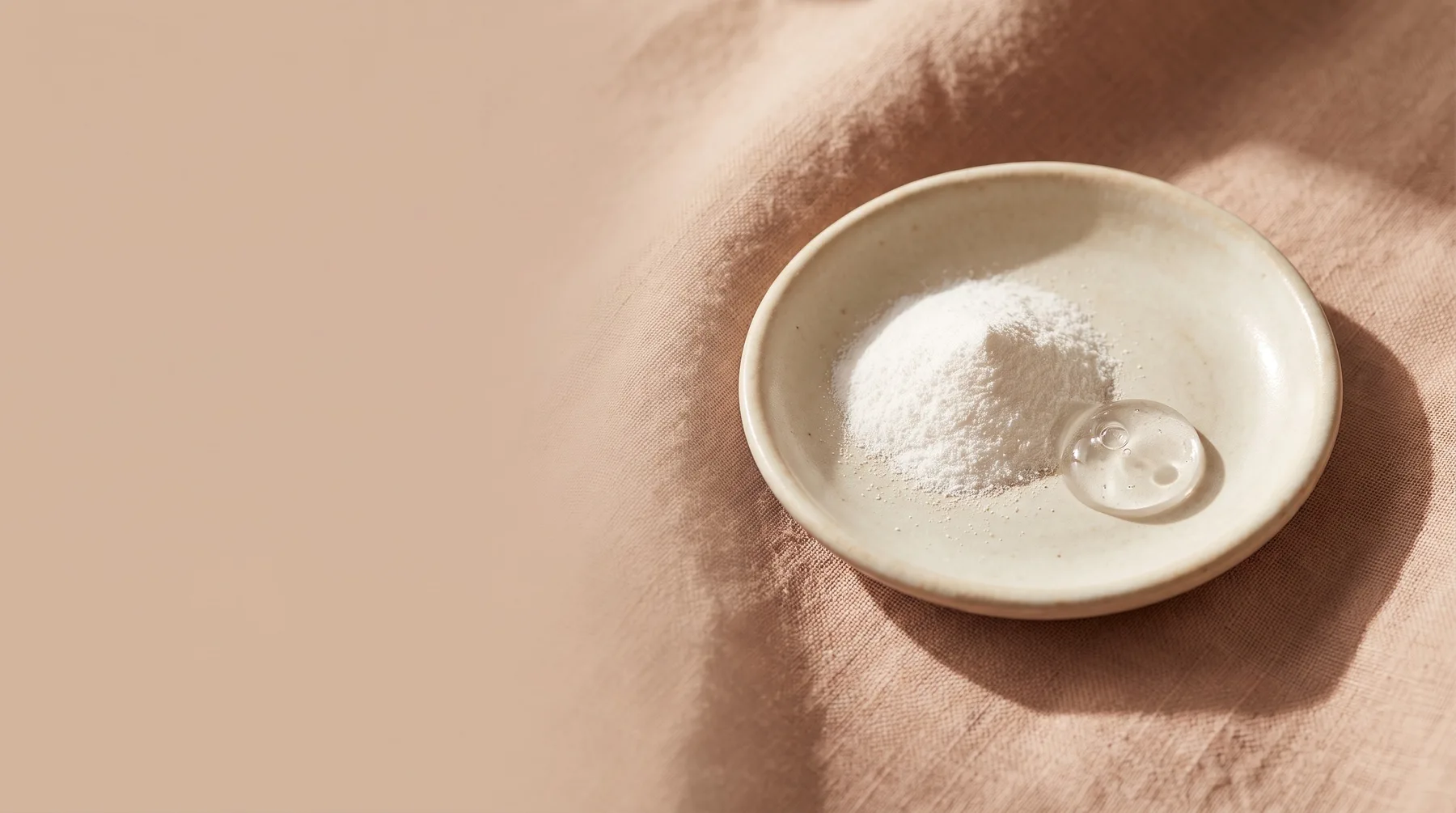 Sodium hyaluronate — a dish of fine white powder beside a droplet of clear gel on warm linen
