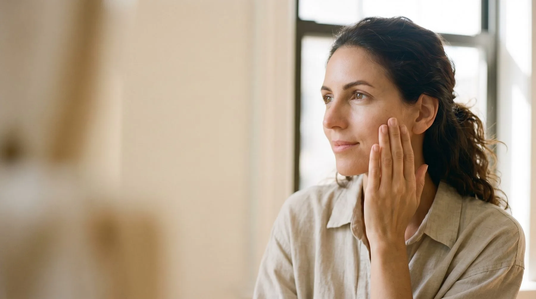 Getting rid of dry skin — pressing moisturizer into the cheek