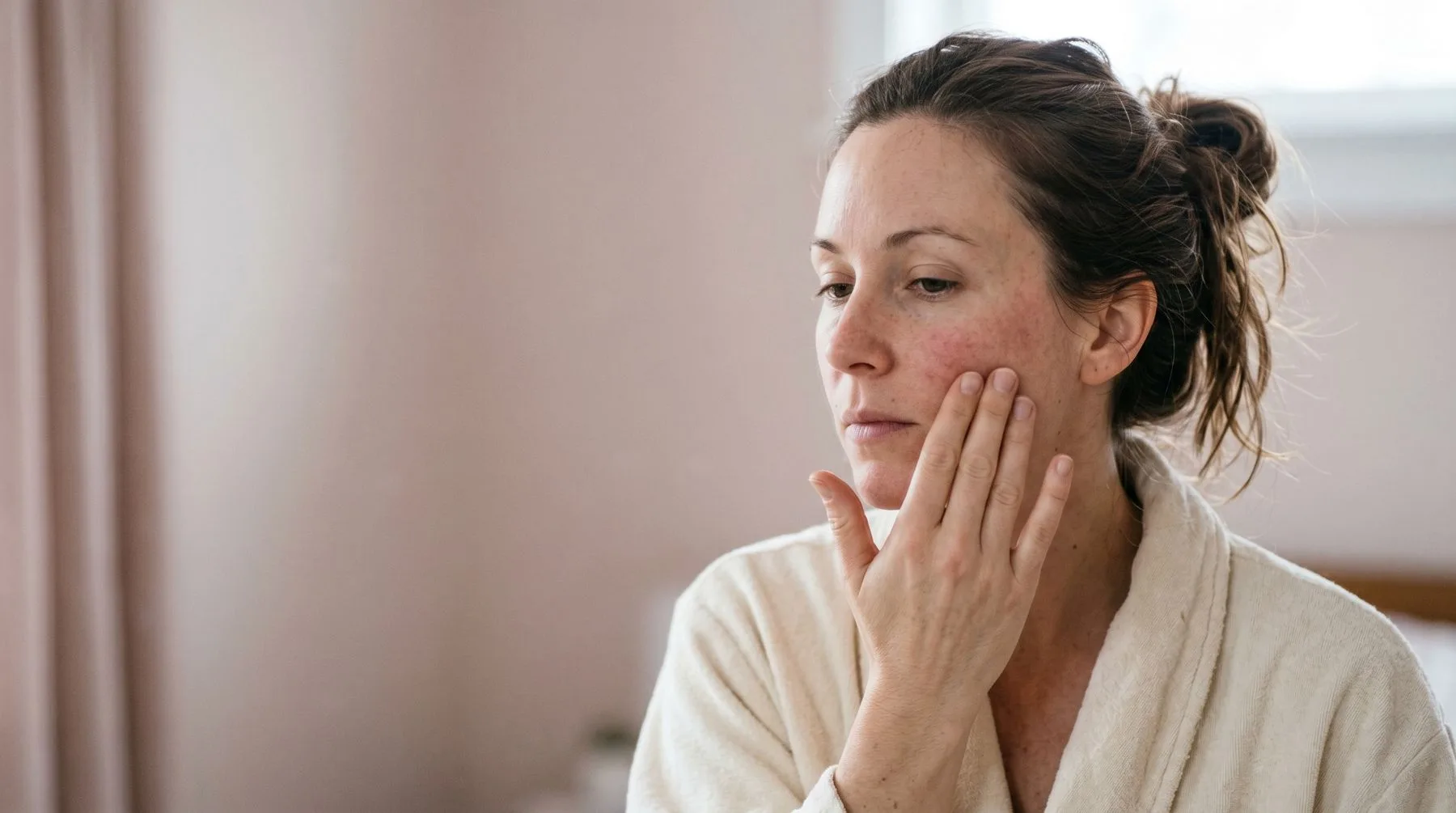 Sensitive skin — calm portrait, hand resting at the cheek