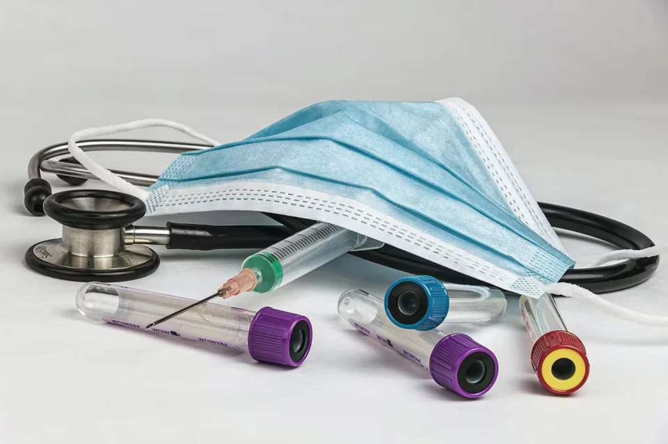 a pile of medical devices. syringes, masks, stethoscope, blood tubes. Signifying the need for preparedness and supply chain resilience.