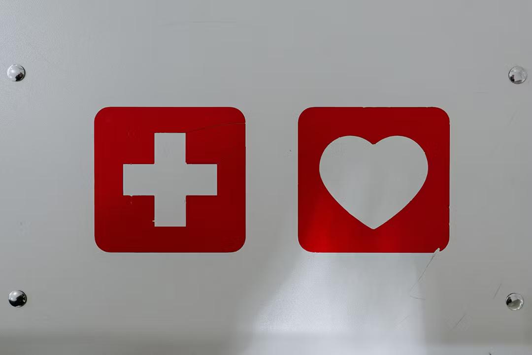 A red cross and a red heart label on a metal box signifying readiness for a medical device recall