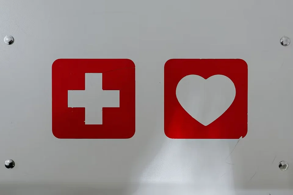A red cross and a red heart label on a metal box signifying readiness for a medical device recall
