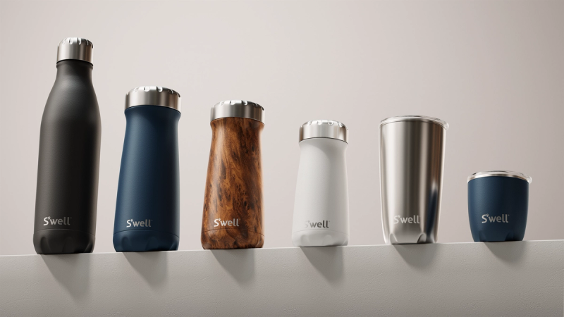 S'well bottle and cup collection in matte black, navy, wood grain, white, and silver arranged on a shelf — product and innovation strategy by Beardwood