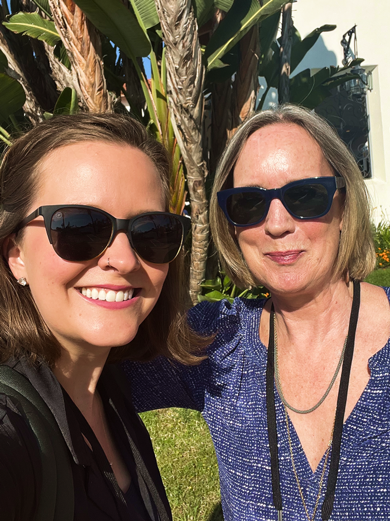 Courtney and Julia Beardwood taking a selfie in front of a palm tree