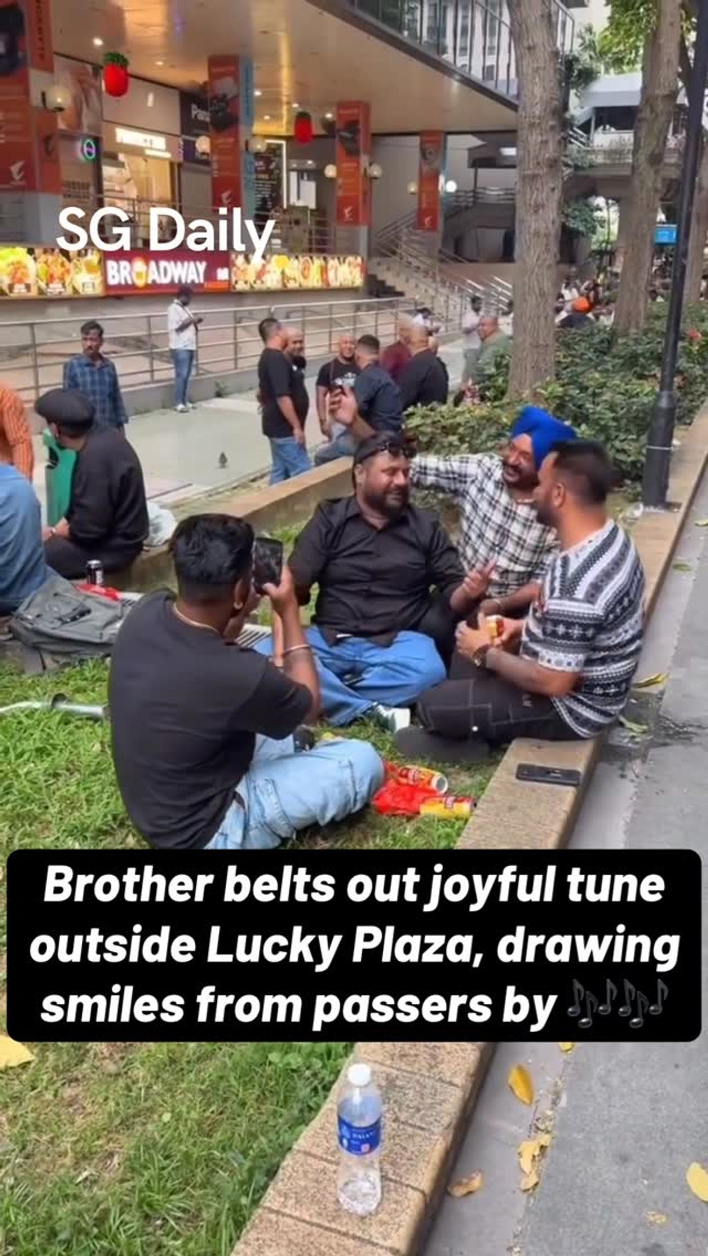Man Sings Outside Lucky Plaza as Passers-By Stop to Watch