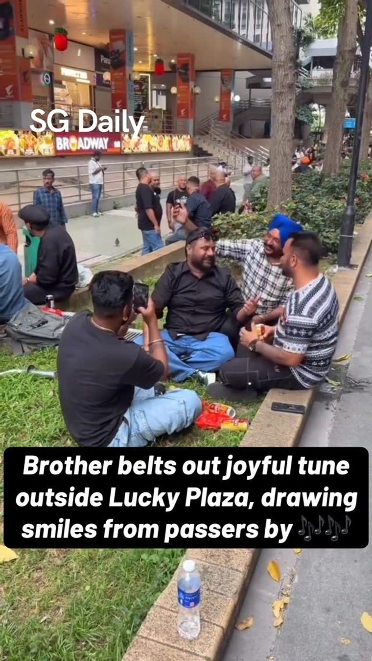 Man Sings Outside Lucky Plaza as Passers-By Stop to Watch