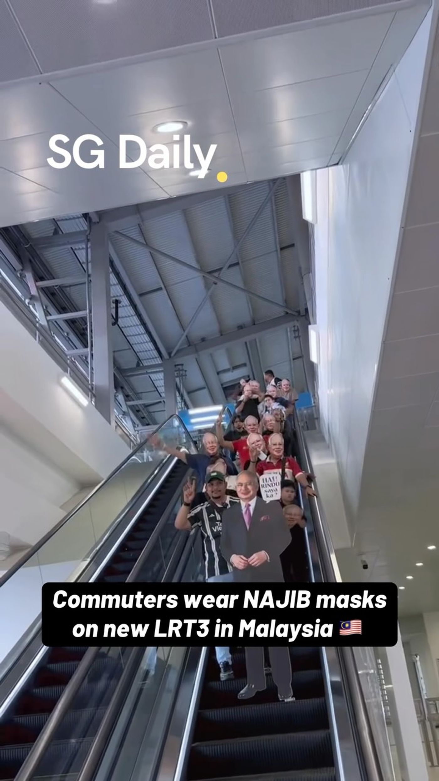 Commuters wear Najib masks on Malaysia's new LRT3