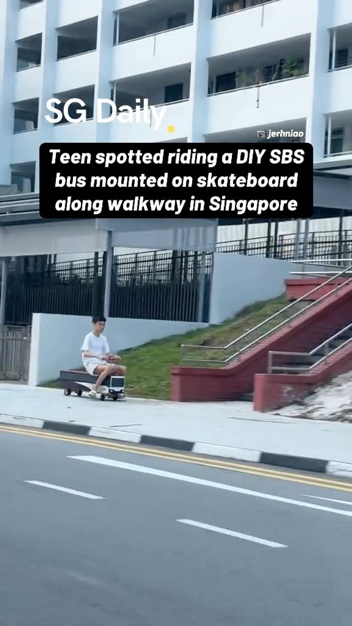 Teen spotted riding a DIY SBS bus mounted on skateboard along walkway in Singapore
