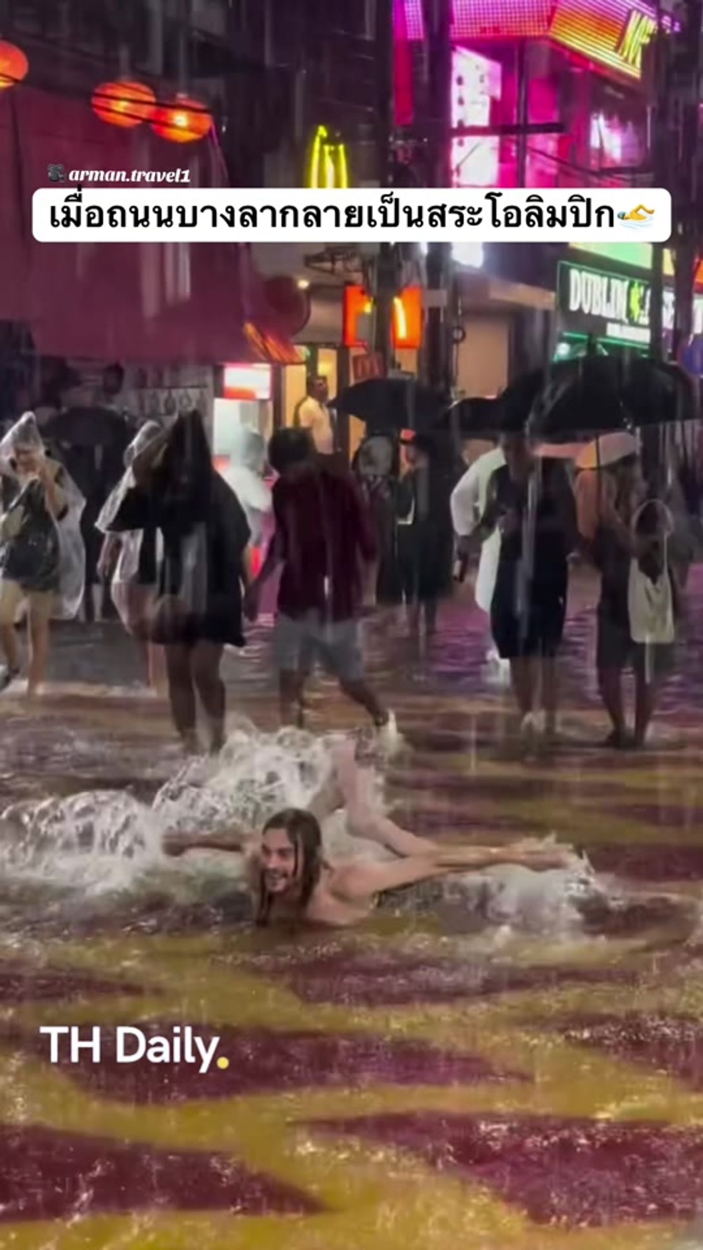 Man swims through floodwater on Phuket's Bangla Road