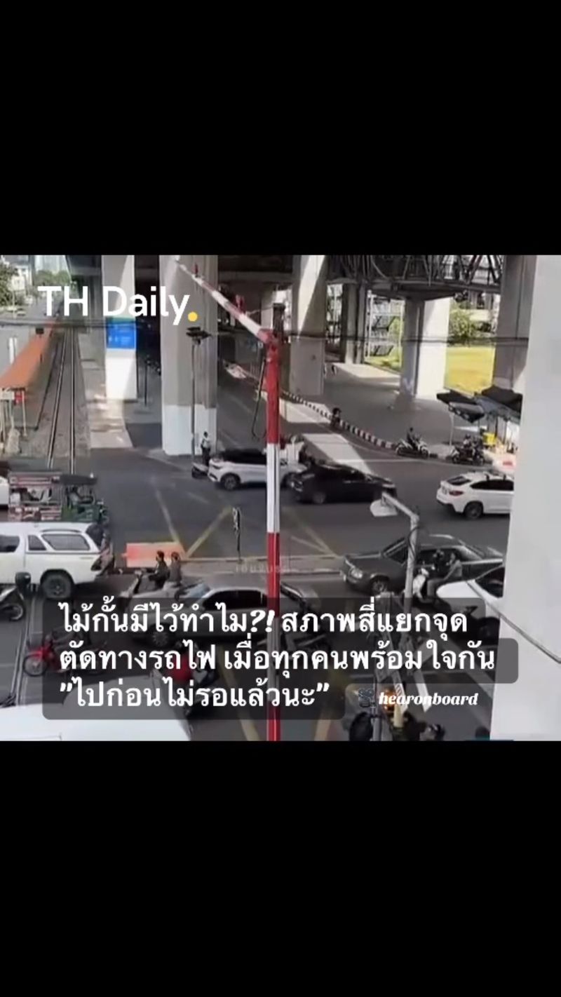 Motorists crowd railway crossing as barrier starts to lower