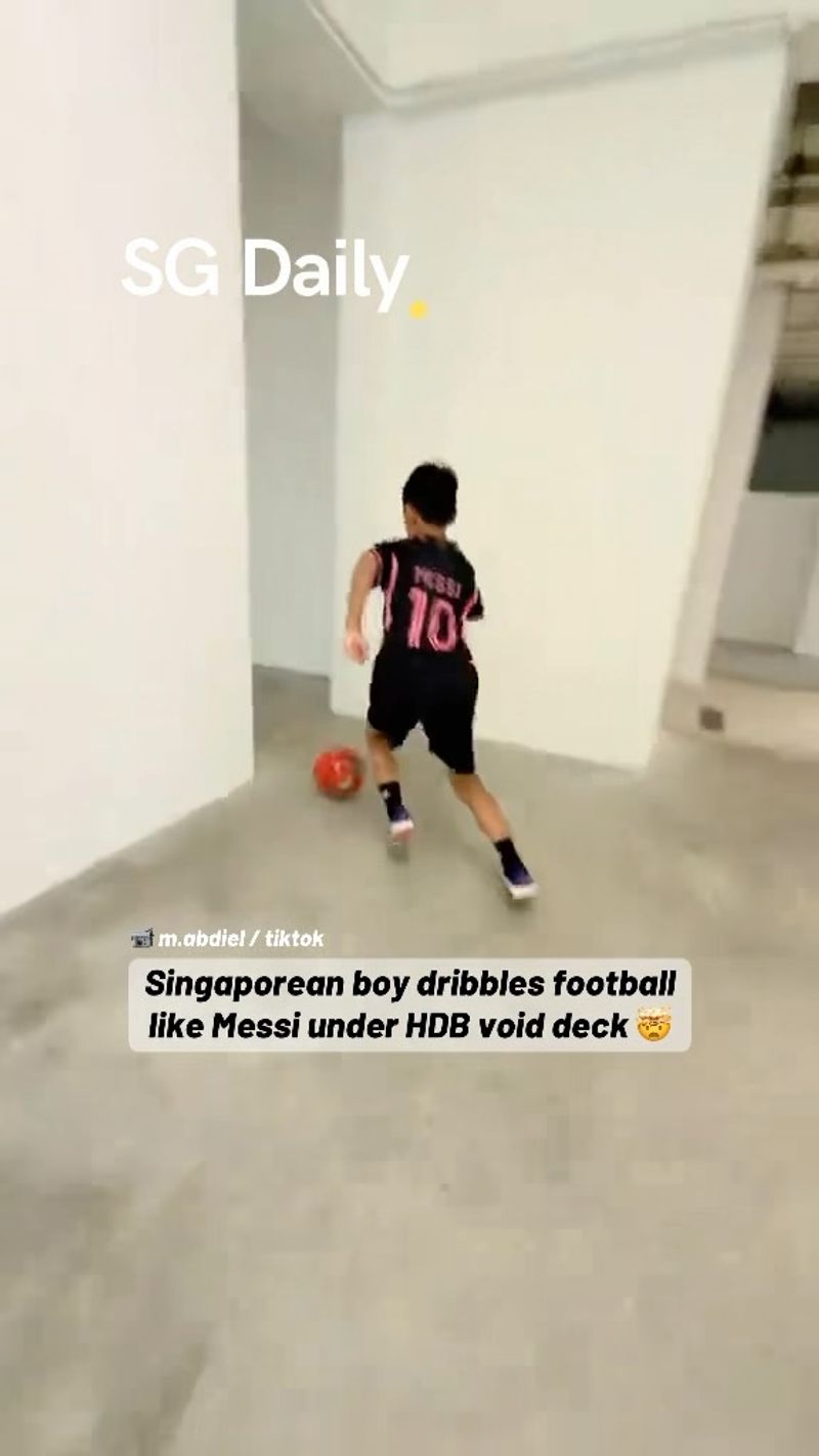 Singaporean boy dribbles football like Messi under HDB void deck
