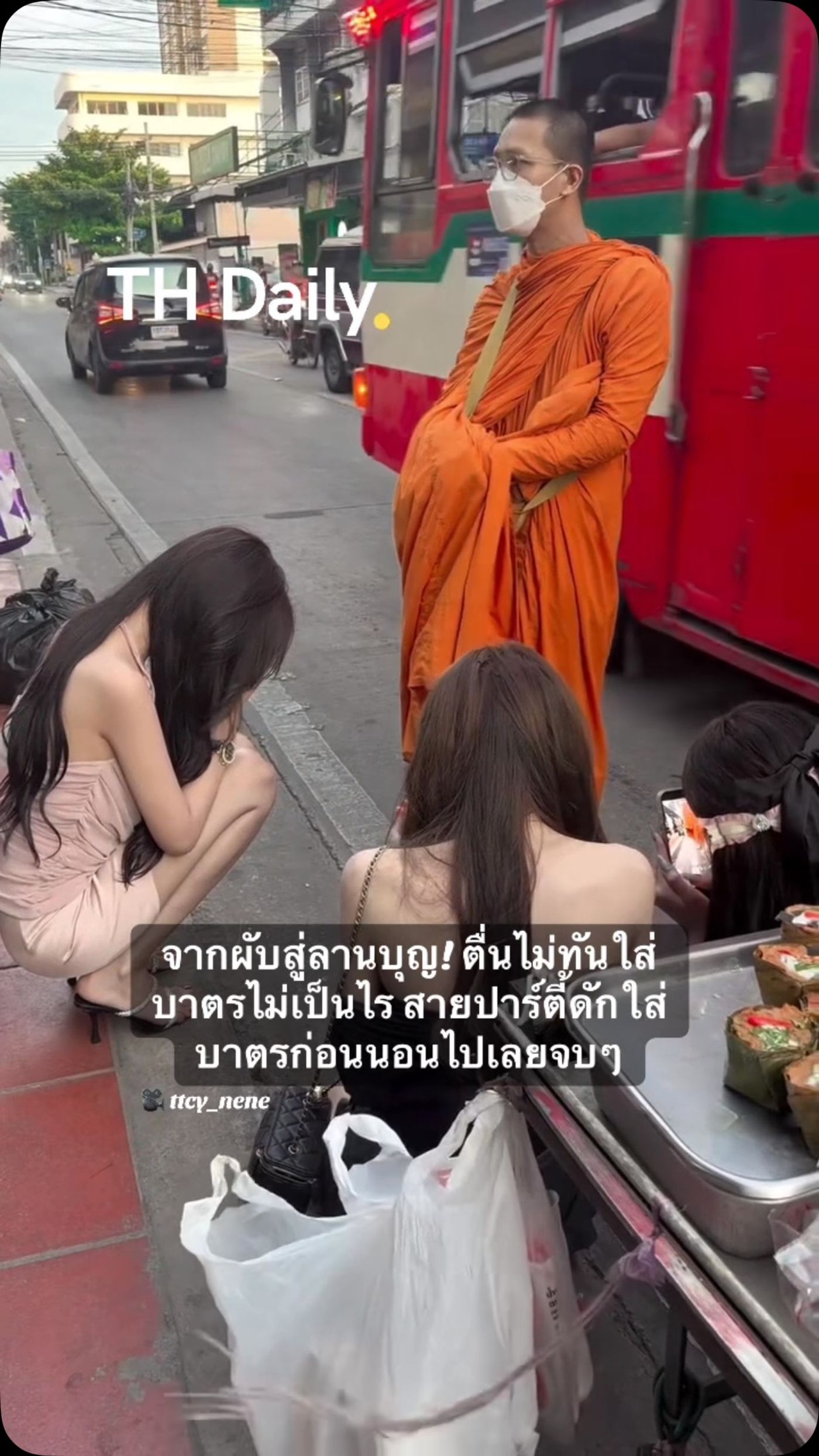 Partygoers stop to give alms after a night out