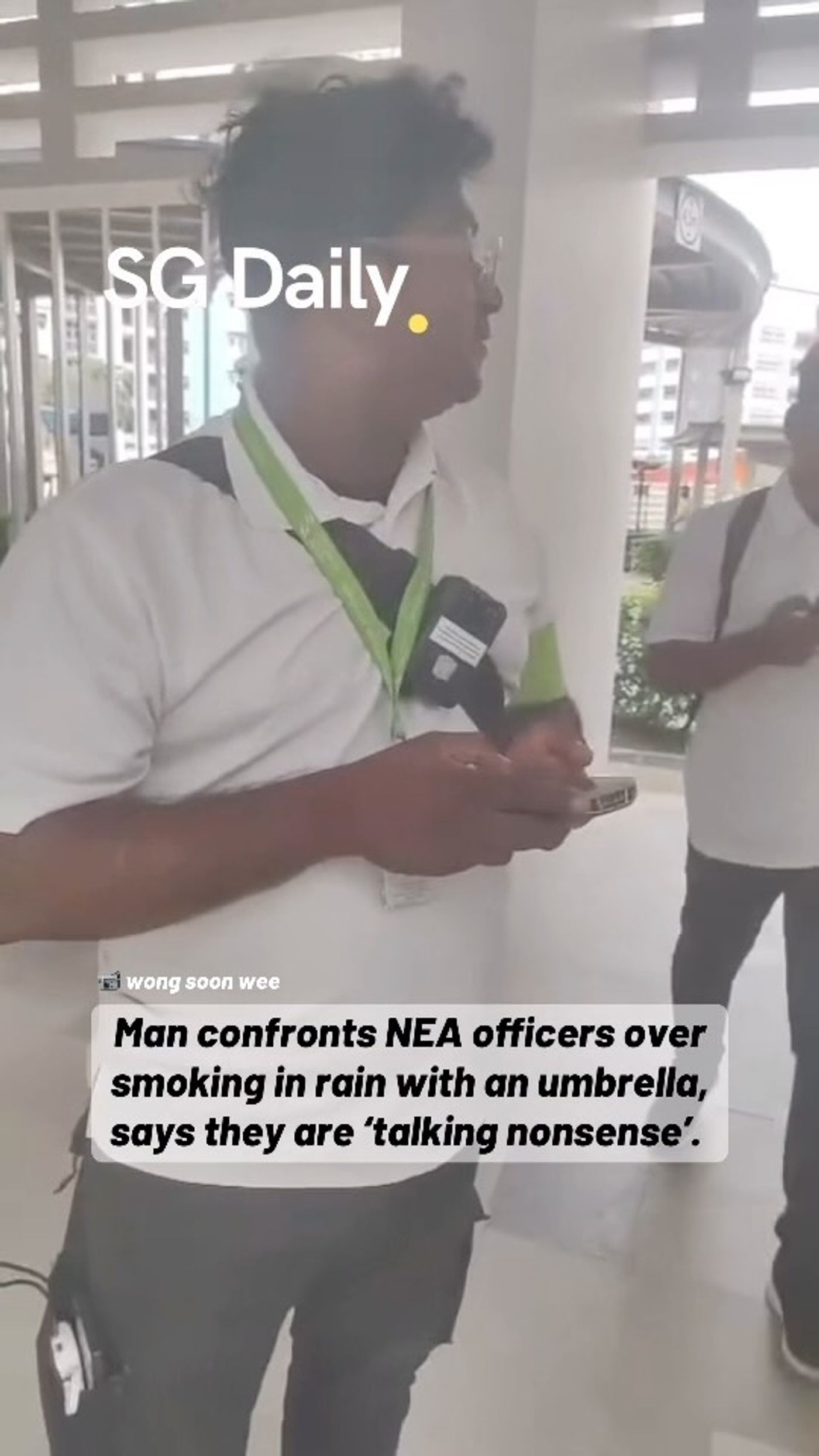 Man confronts NEA officers over smoking in the rain