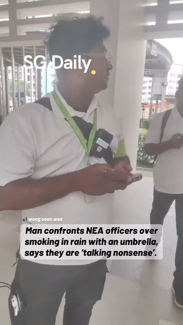 Man confronts NEA officers over smoking in the rain