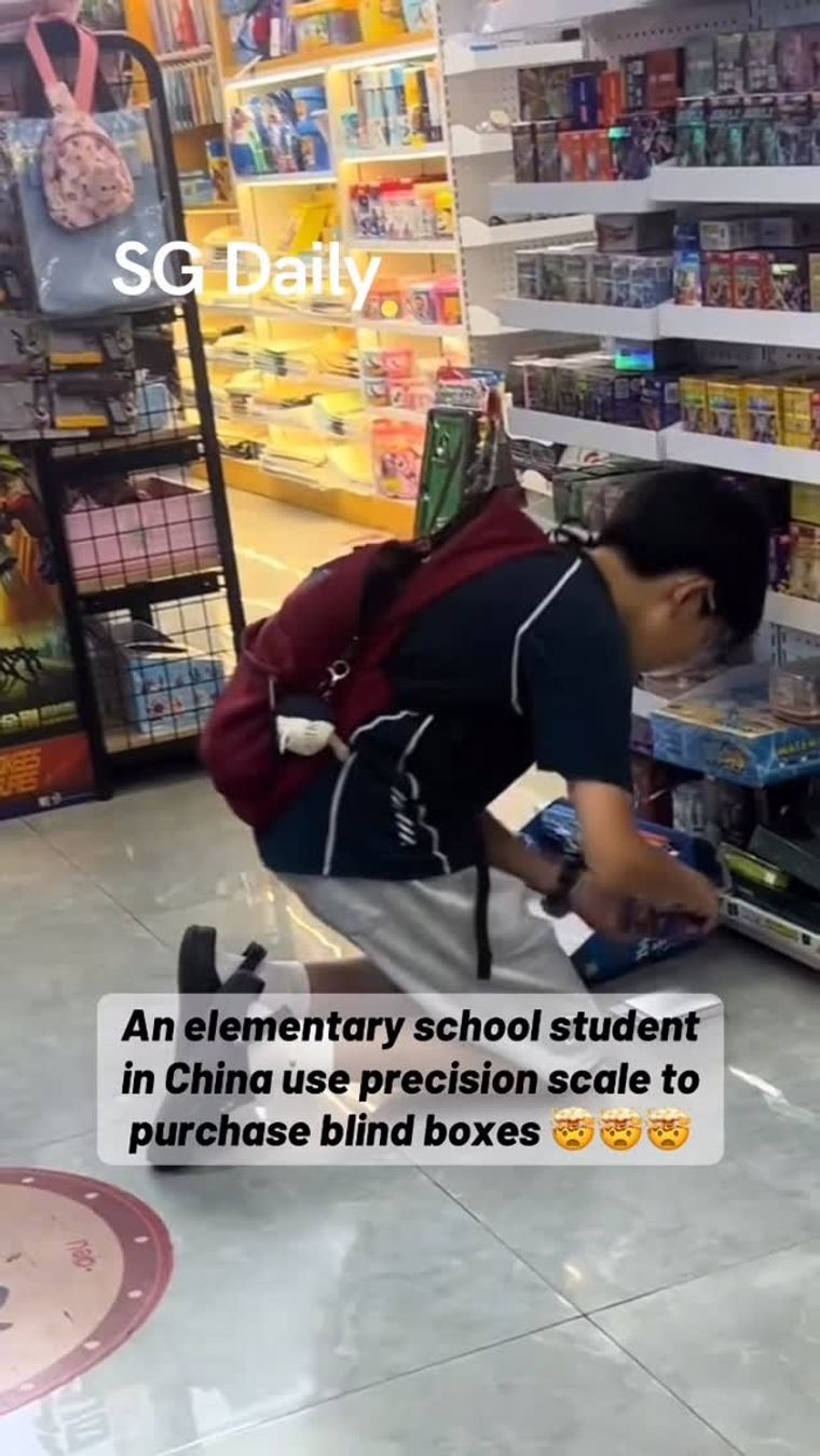 An elementary school student in China use precision scale to purchase blind boxes