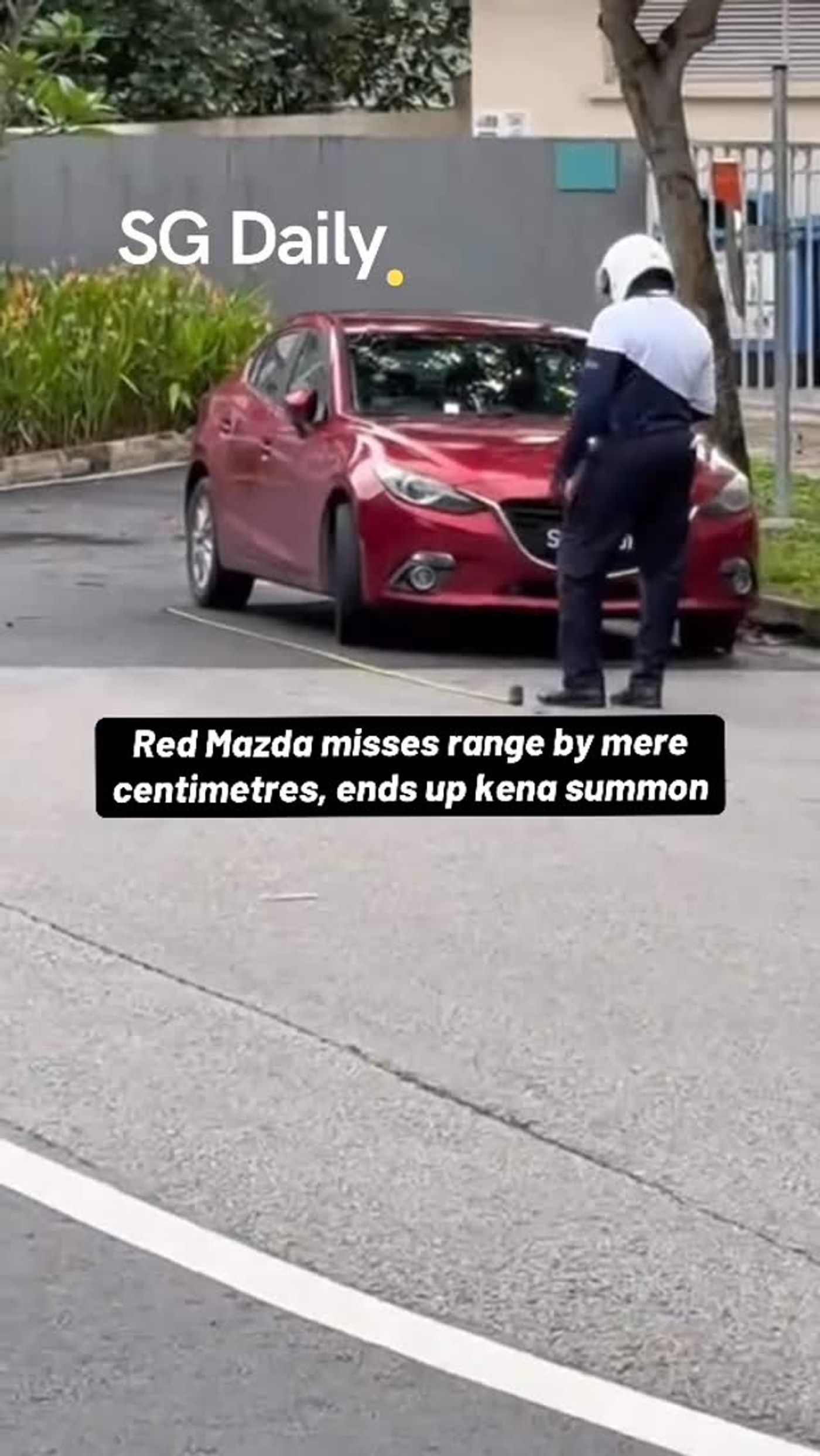 Red Mazda gets parking notice after missing lot boundary by centimetres