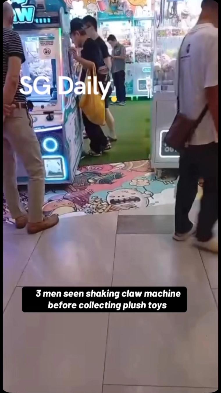 3 men seen shaking claw machine before collecting plush toys