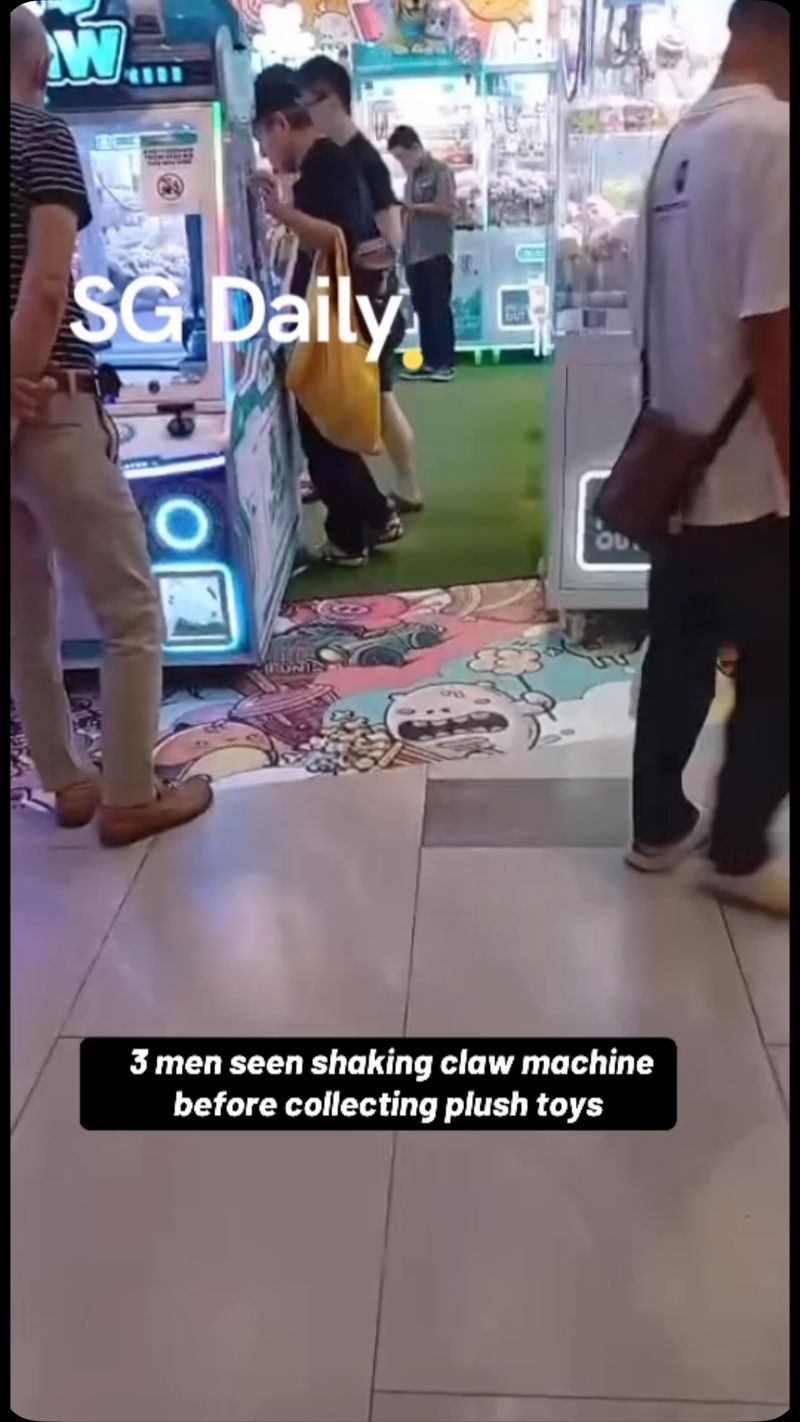 3 men seen shaking claw machine before collecting plush toys
