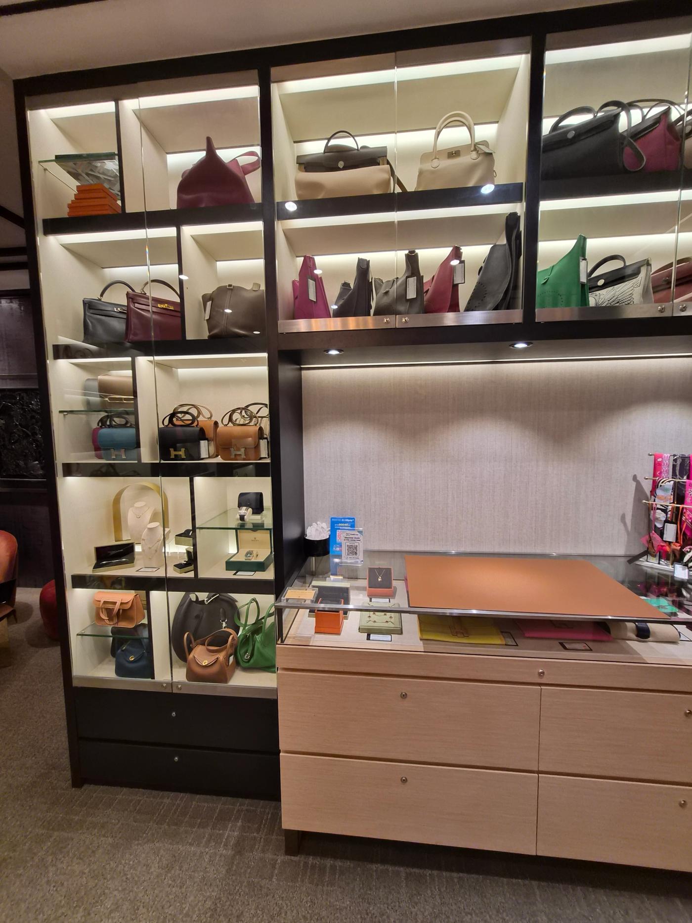 Handbags displayed on shelves inside BJ Luxury.