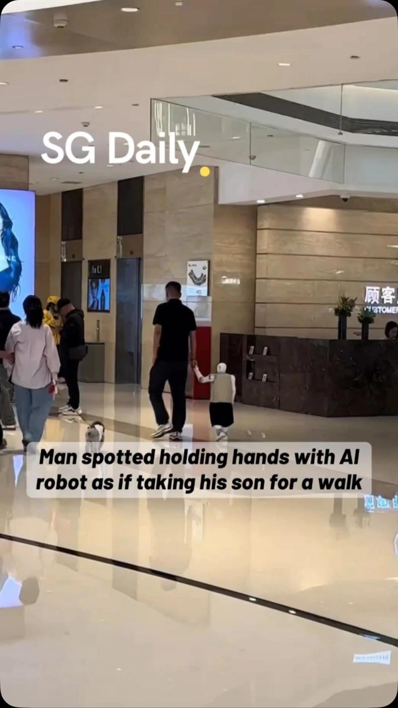 Man spotted holding hands with AI robot as if taking his son for a walk