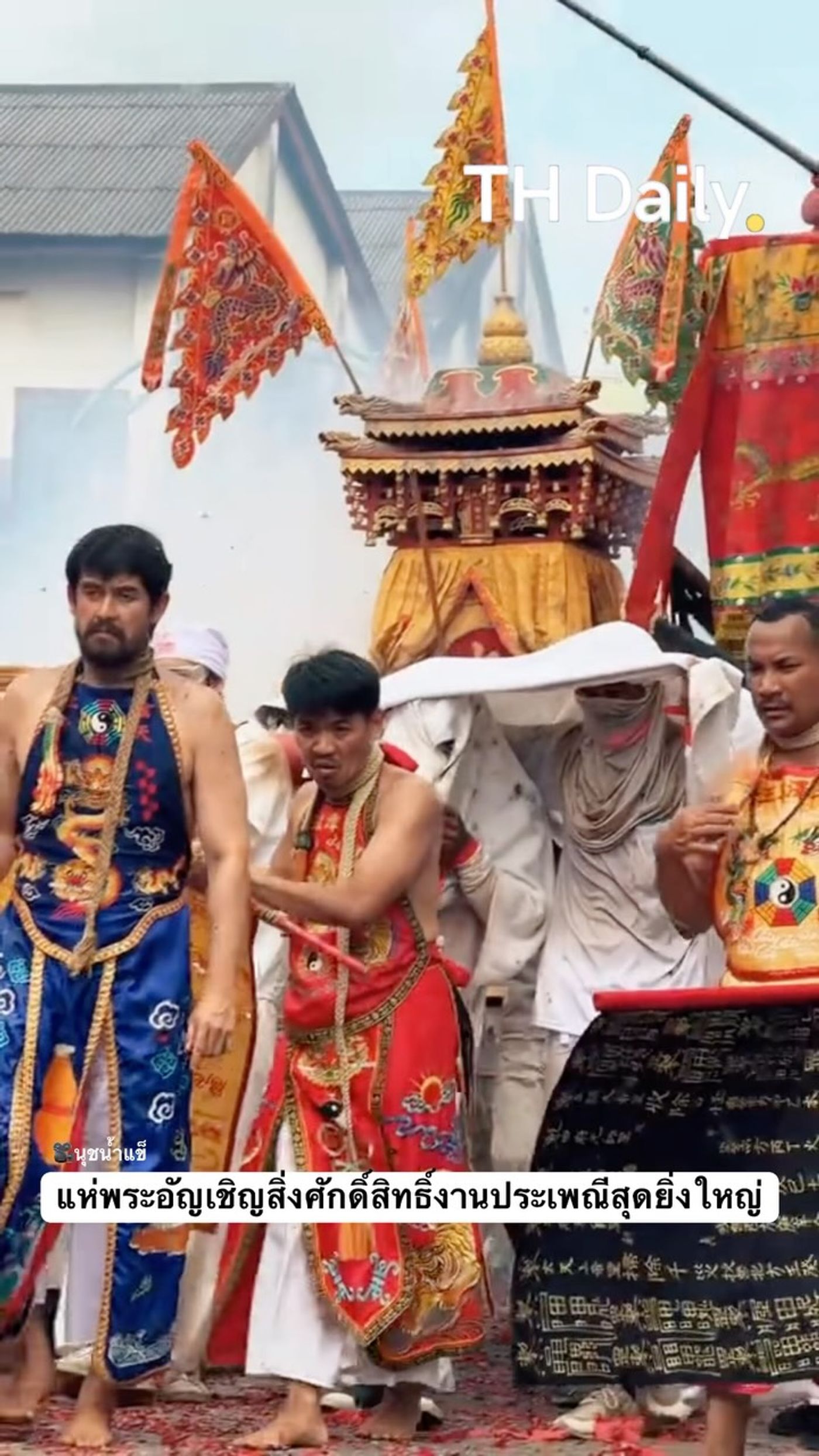 Devotees carry shrine through smoke-filled street procession