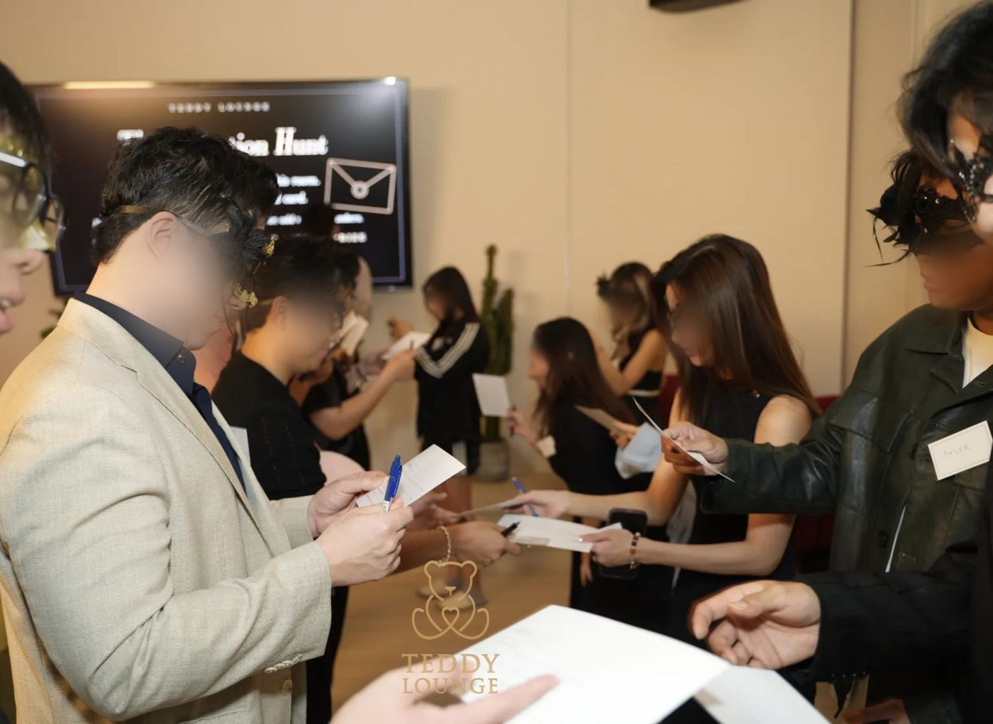 Masked guests compare cards during Teddy Lounge’s Invitation Hunt.