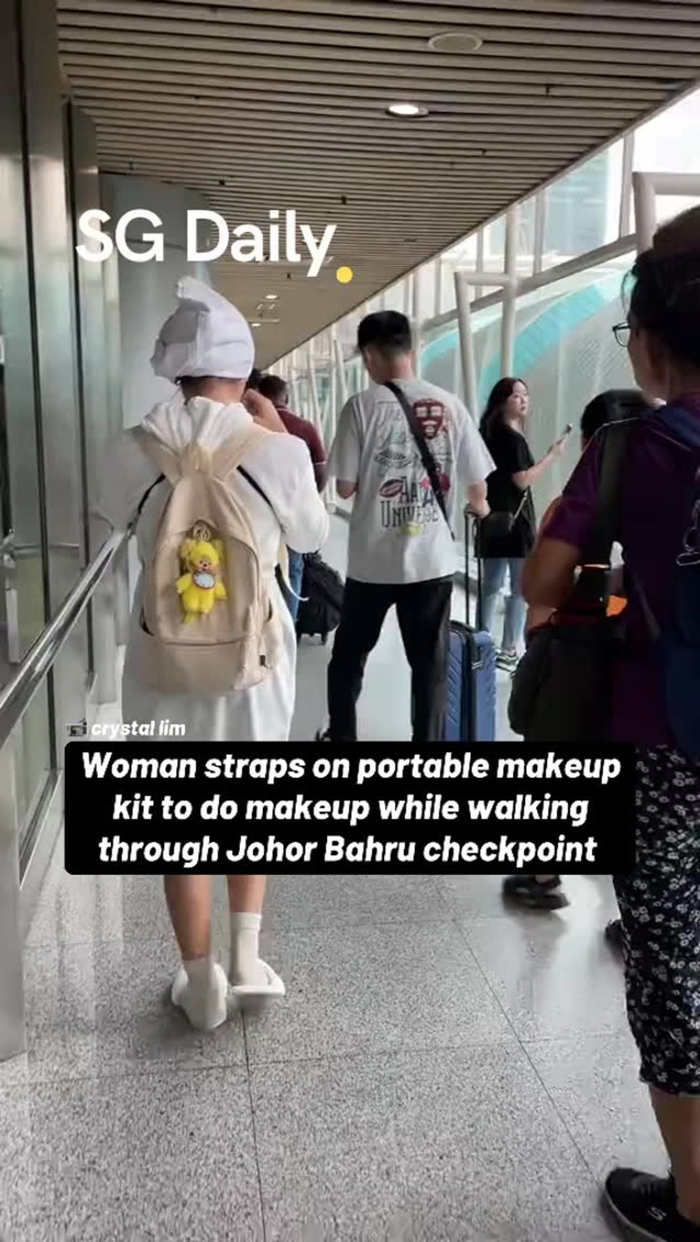 Woman walks through JB checkpoint with portable makeup kit