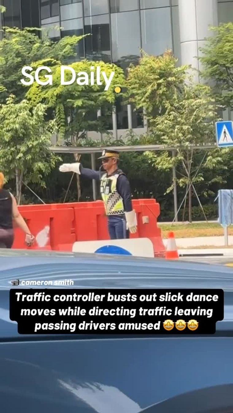 Traffic controller busts out slick dance moves while directing traffic