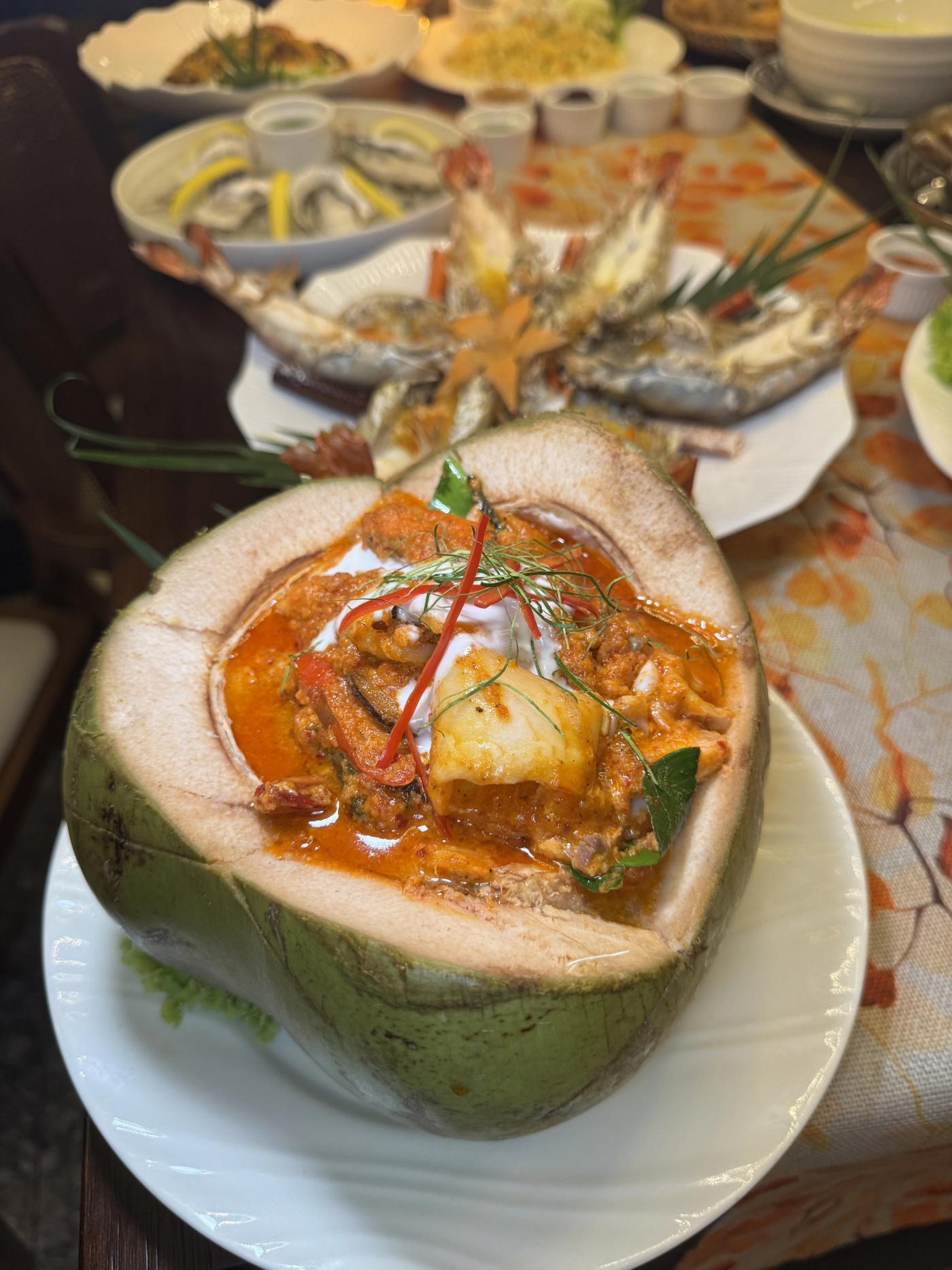 Seafood curry served inside a young coconut at Lebua Thai