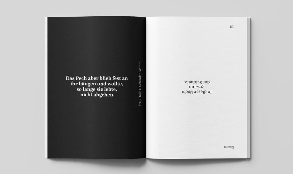 Black page carrying a white quote, facing a bare white page whose single line of text is set upside down