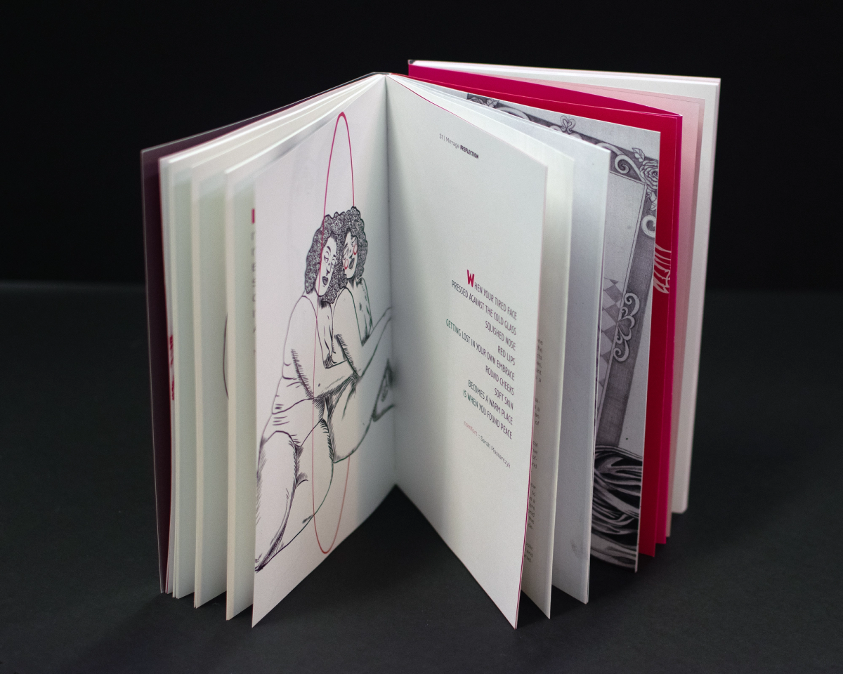 Hardcover book standing open on black, magenta-edged pages, ink drawing of two entwined figures