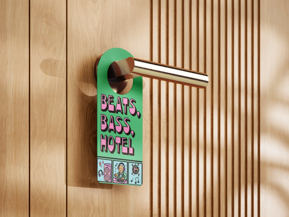 Mockup of the green door hanger looped over a brass lever handle on a slatted oak hotel door