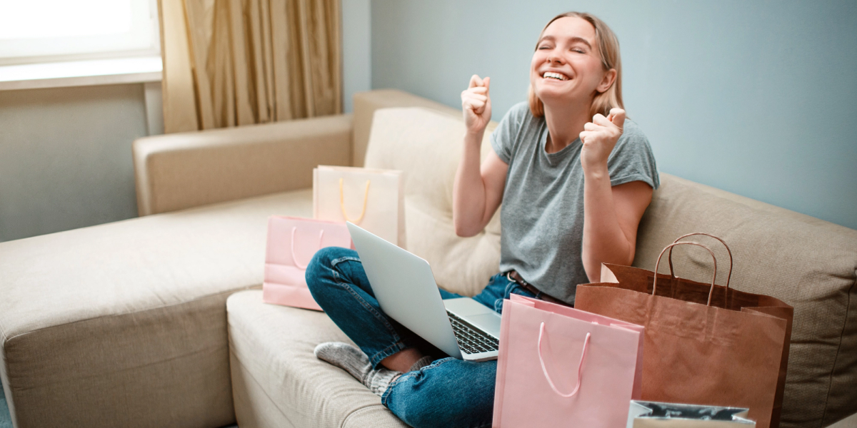 Girl happy on couch after shopping