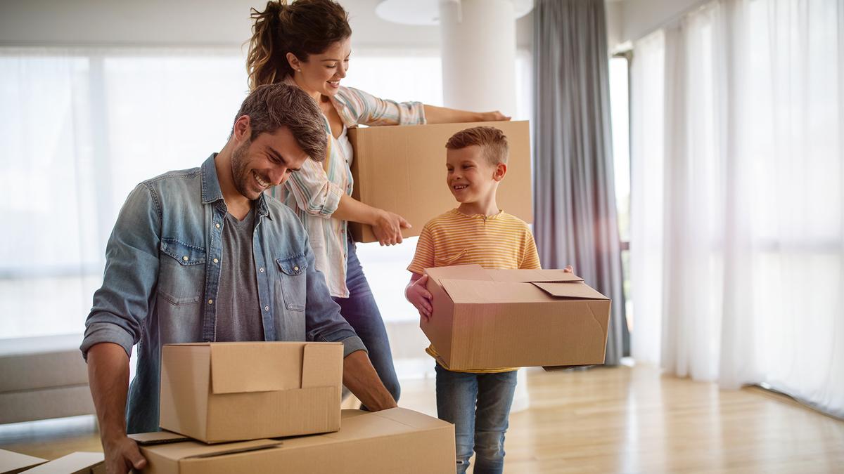 family with packed boxes moving house