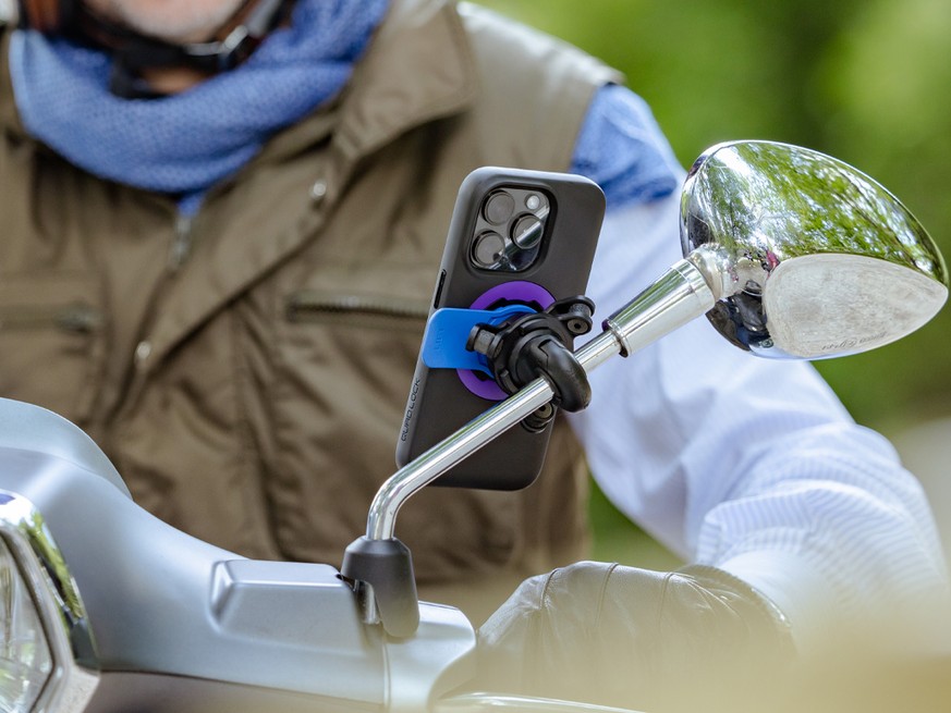 Quad Lock Mirror Mount with Vibration Dampener and iPhone with purple MAG Ring mounted