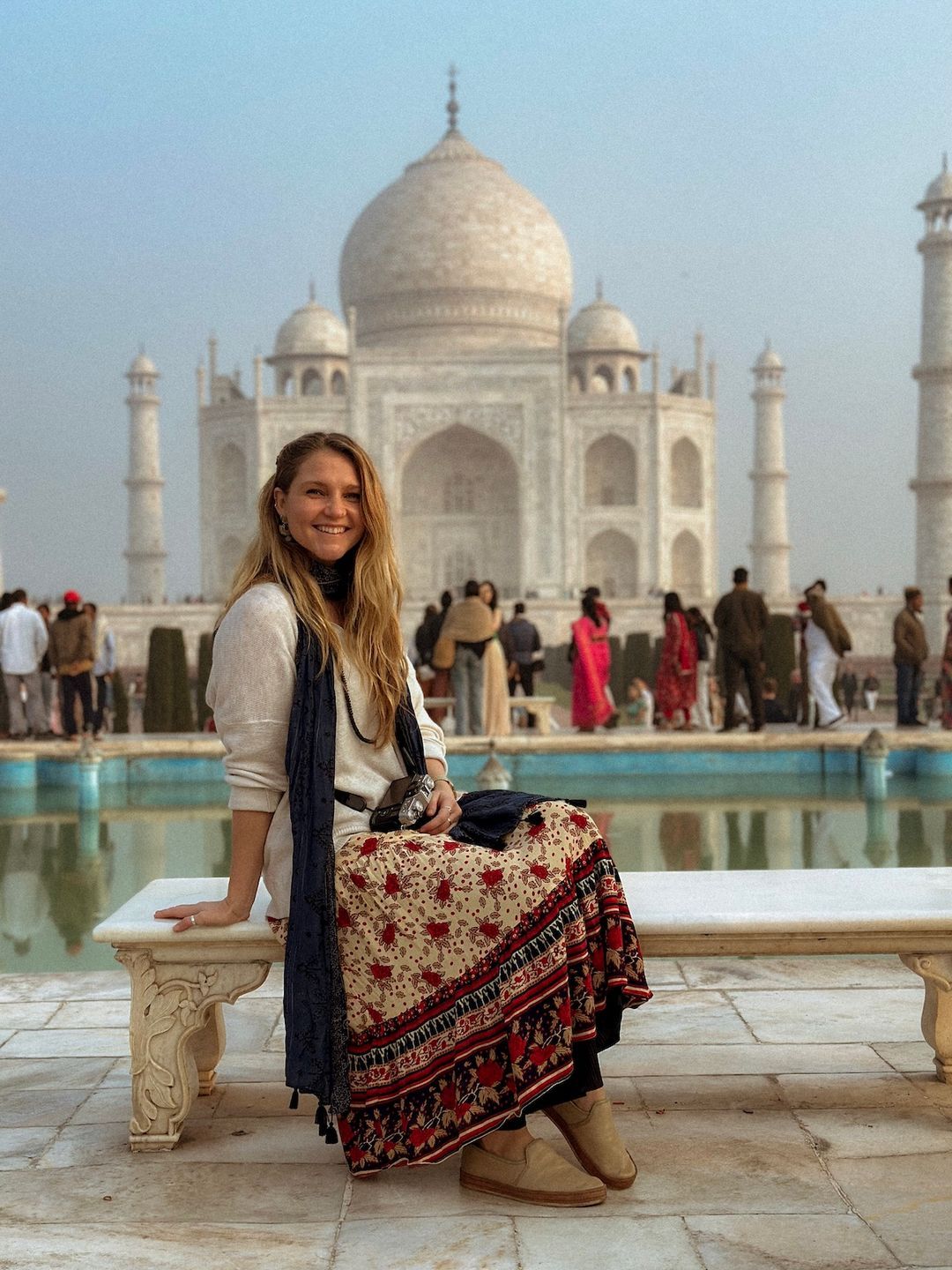 Drea smiling in front of the Taj Mahal during her travels in India