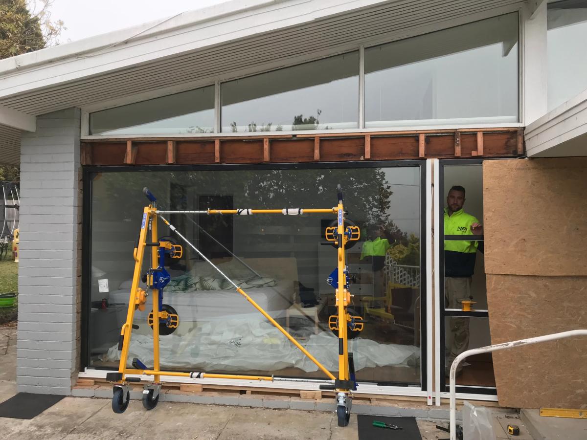 Quattrolifts vacuum lifter holding a large glass panel on a residential glazing job
