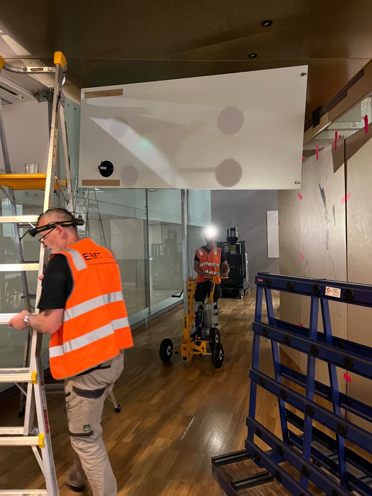 Quattrolifts glass lifter and art handlers moving a large glass panel inside a museum gallery