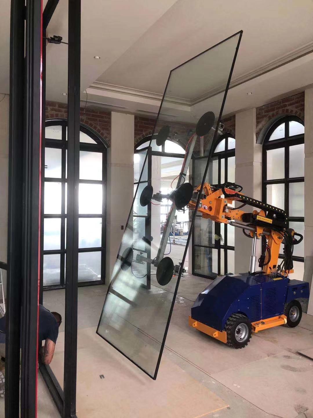 Quattrolifts robotic glass lifter carrying a large glass partition pane in a heritage museum interior with arched windows