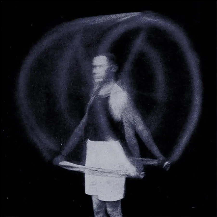 A long-exposure black and white photo of a man jumping rope, creating luminous arcs and blurred motion effects.