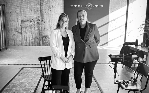 Two people standing infront of Stellantis banner