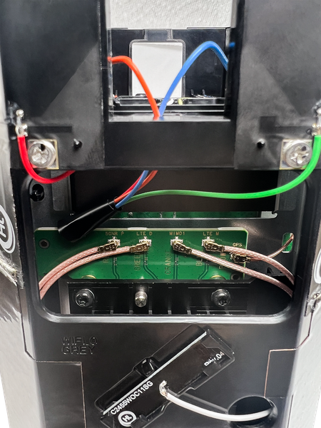 Installing the U.FL to SMA-female pigtail adapters. 