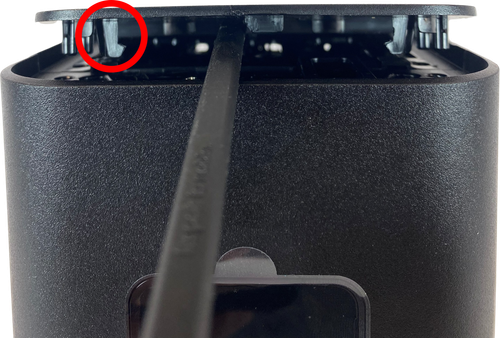 Gently pry off each of the four corners of the top cover.