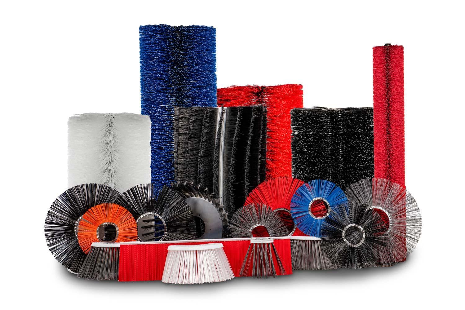 Various brooms against a white background