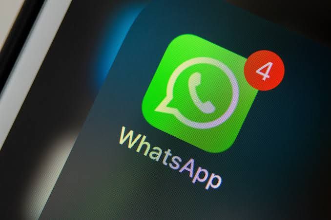A WhatsApp logo sign showing a message notification: The platform is announcing radical changes affections iPhones 