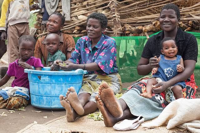 Villagers in Malawi preparing food: The country is piloting direct aid to needy persons