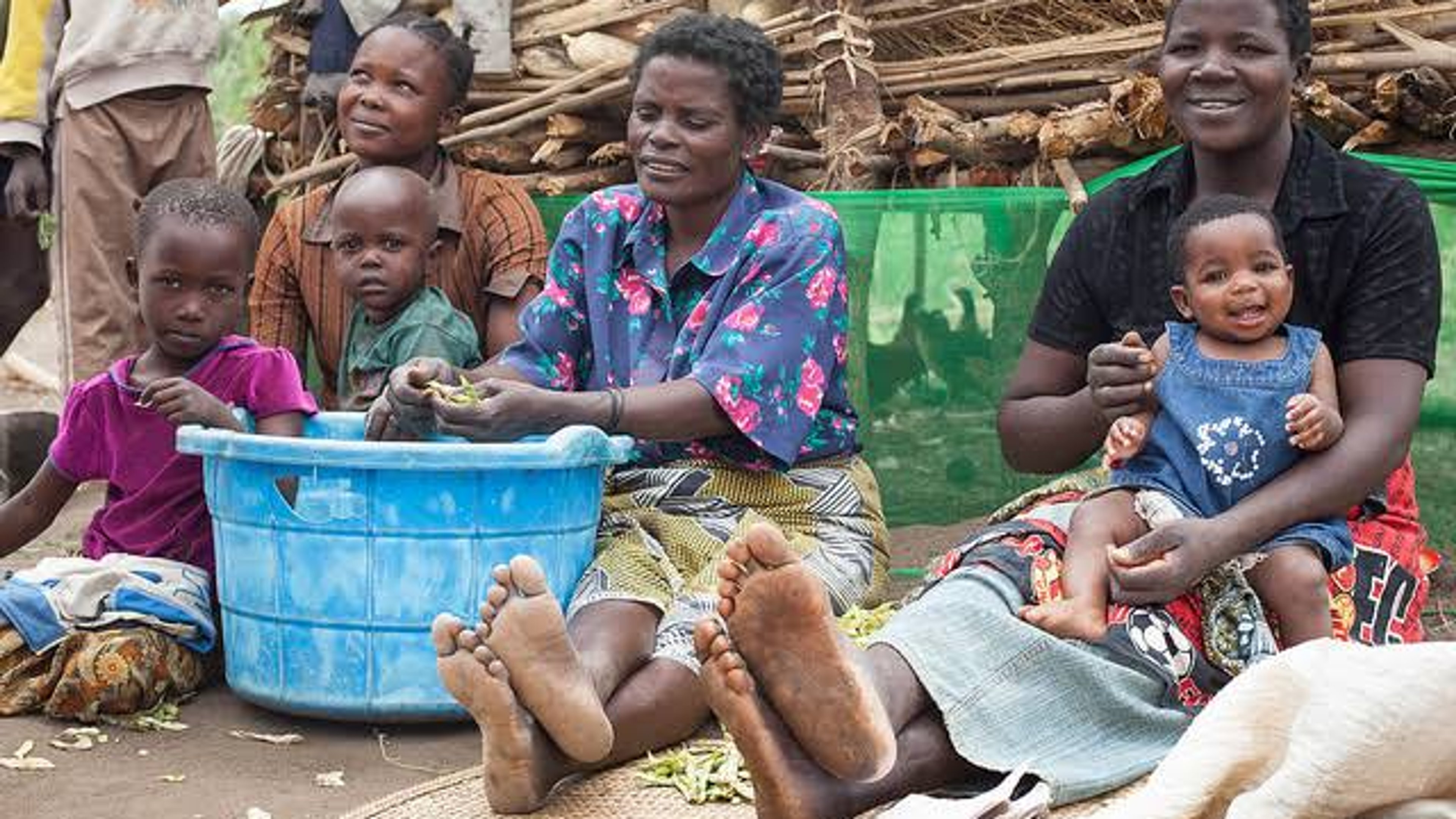 Villagers in Malawi preparing food: The country is piloting direct aid to needy persons