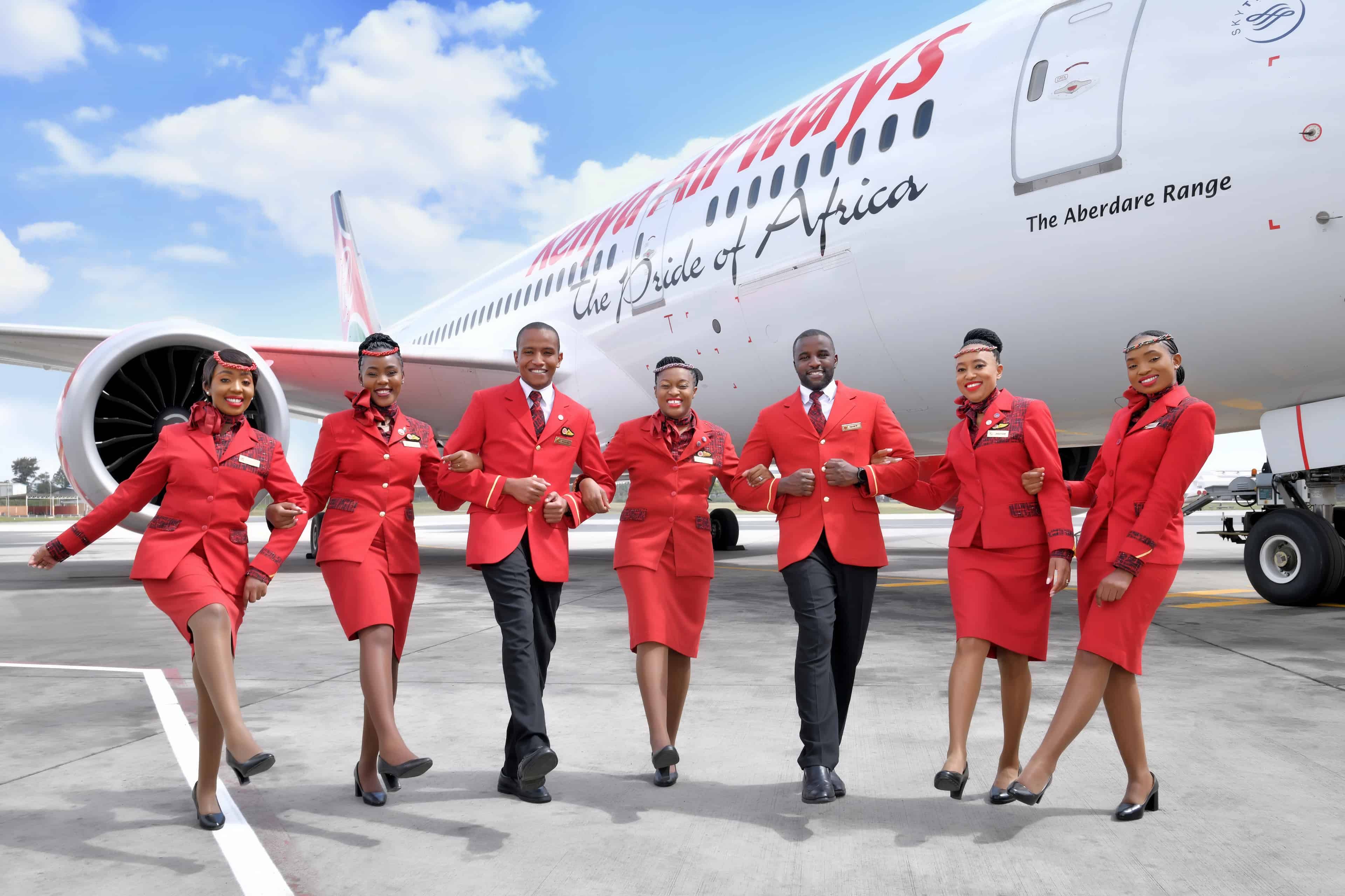 Kenya Airways staff pose behind their aircraft 