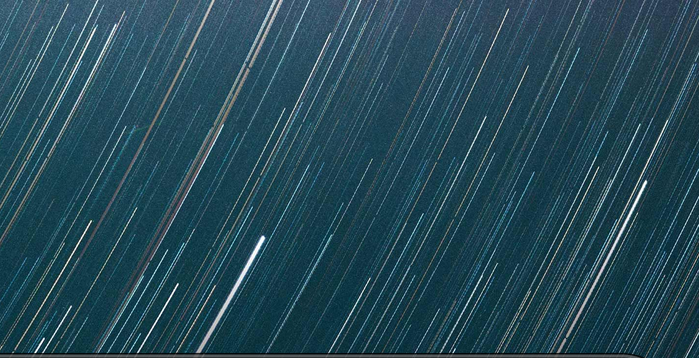 A terminal window showing the command "npx skills add sanity-io/agent-toolkit" over a background of white star trails on dark blue.