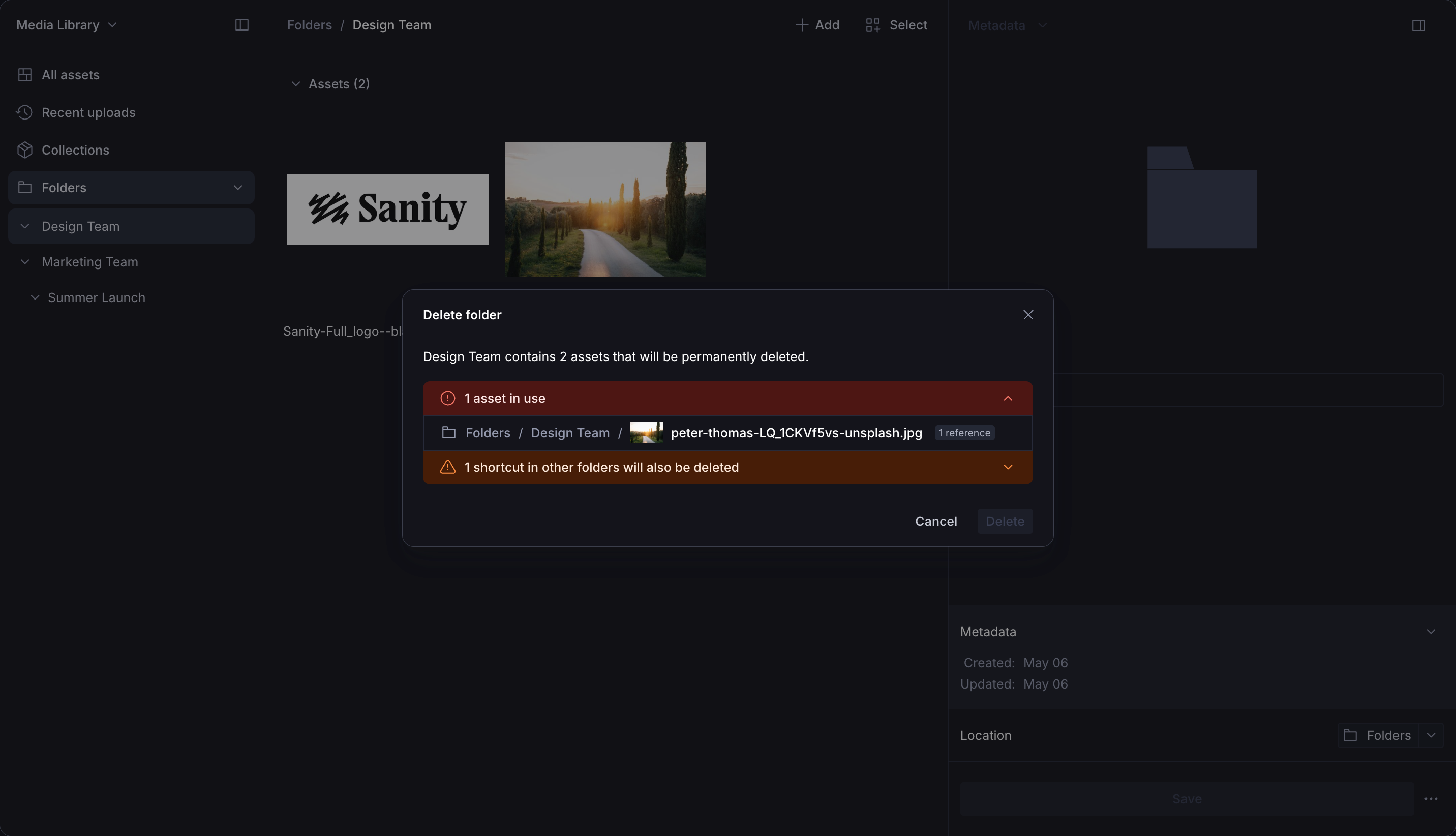 A dark-themed media library displays a "Delete folder" dialog for "Design Team," warning that 2 assets will be permanently deleted, including one in use and one shortcut from other folders.